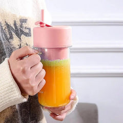 Portable rechargeable juice blender with straw.